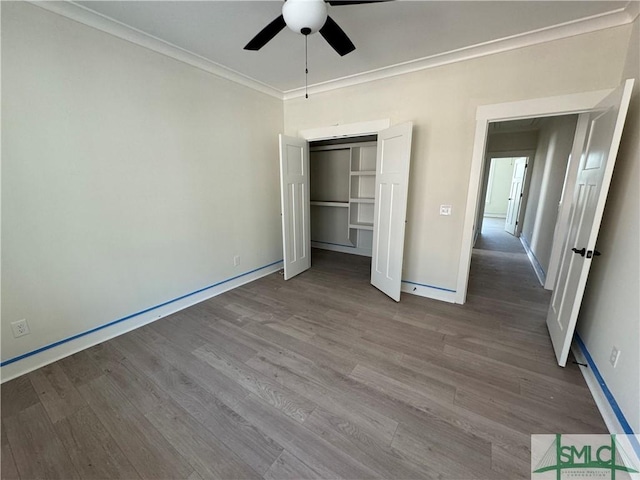 unfurnished bedroom with ornamental molding, a closet, ceiling fan, and light hardwood / wood-style flooring