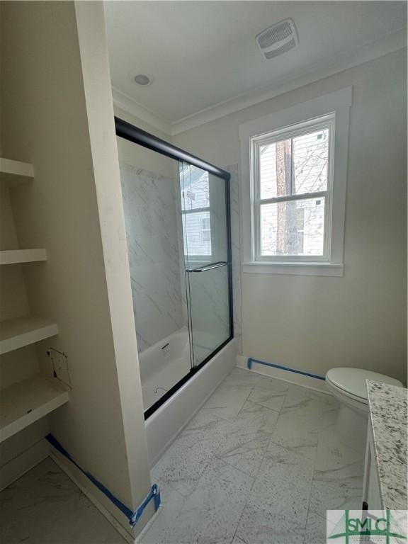 full bathroom with bath / shower combo with glass door, ornamental molding, vanity, and toilet