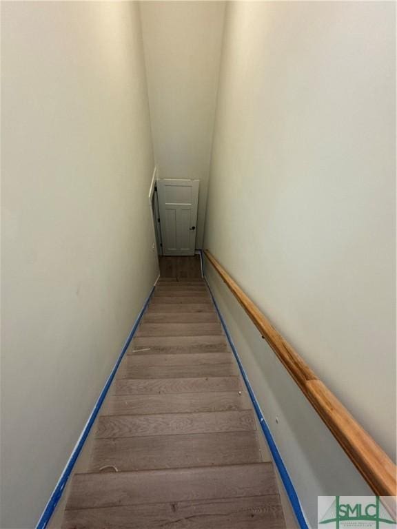 stairway with hardwood / wood-style floors