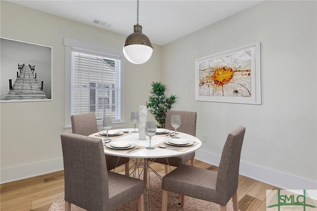 dining area with wood-type flooring