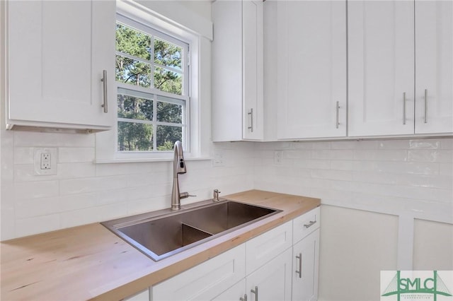 kitchen featuring white cabinetry and sink