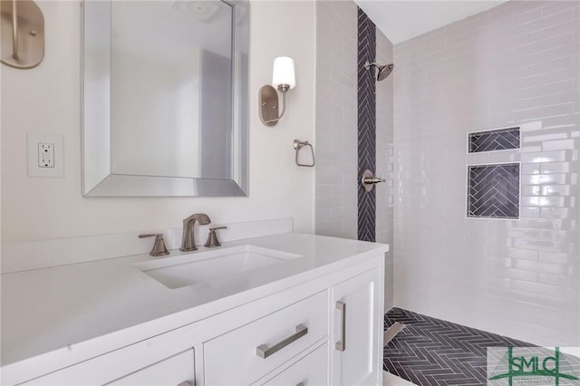 bathroom with vanity and tiled shower