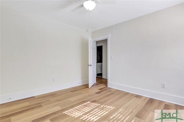 spare room with ceiling fan and light wood-type flooring