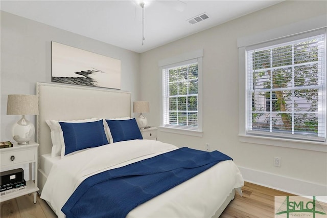 bedroom with light wood-type flooring and ceiling fan