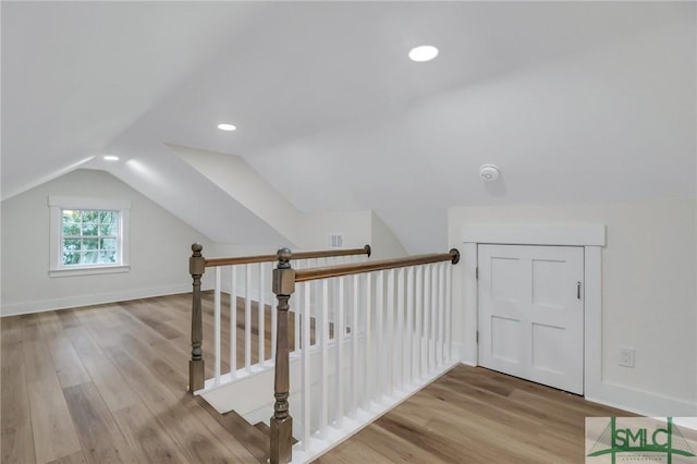 bonus room featuring light hardwood / wood-style flooring and vaulted ceiling