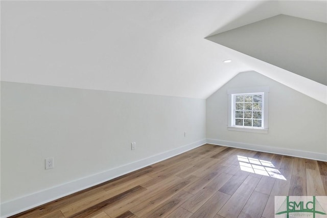 bonus room with light hardwood / wood-style flooring and vaulted ceiling