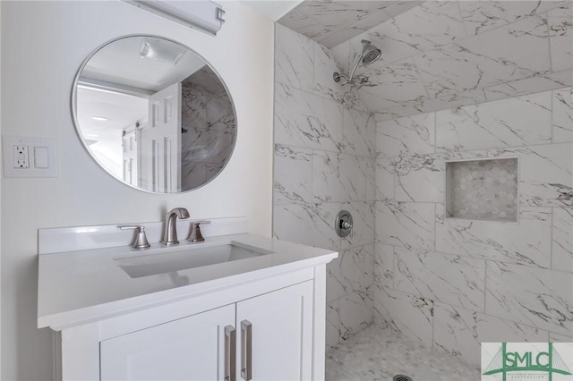 bathroom featuring vanity and tiled shower