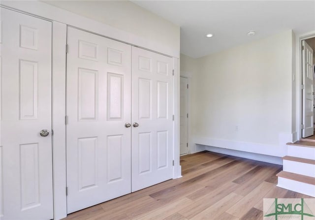 unfurnished bedroom featuring a closet and light hardwood / wood-style floors