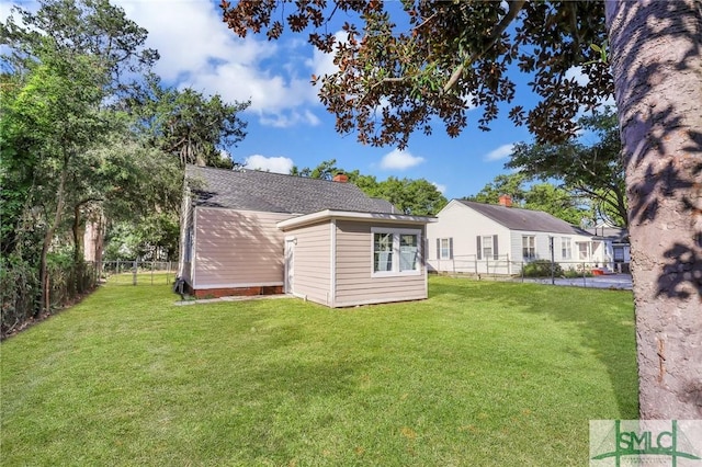 rear view of property with a lawn