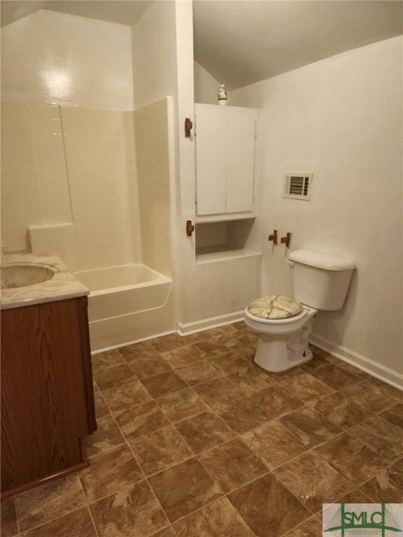 full bathroom featuring vanity, toilet, shower / bathtub combination, and lofted ceiling