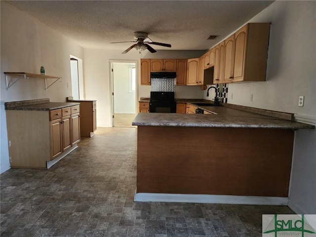 kitchen with kitchen peninsula, black range oven, a textured ceiling, ceiling fan, and sink