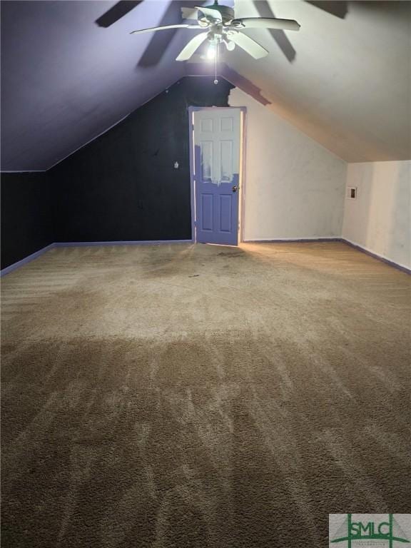 additional living space featuring carpet flooring and vaulted ceiling