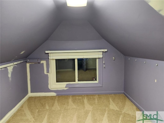 additional living space featuring carpet and lofted ceiling