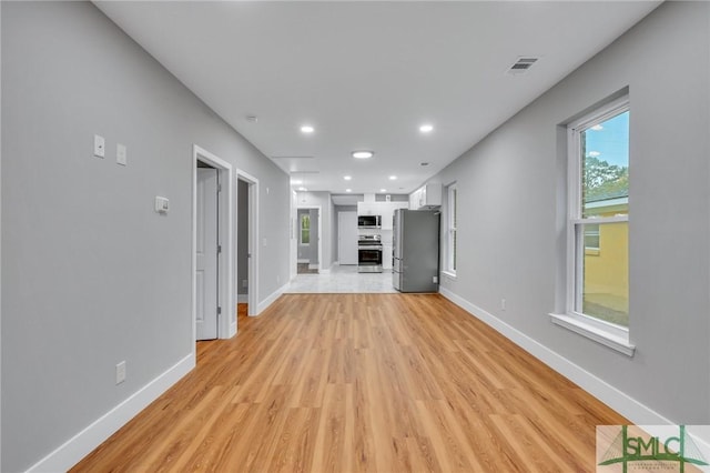 unfurnished living room with light hardwood / wood-style flooring