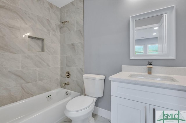 full bathroom with toilet, vanity, and tiled shower / bath