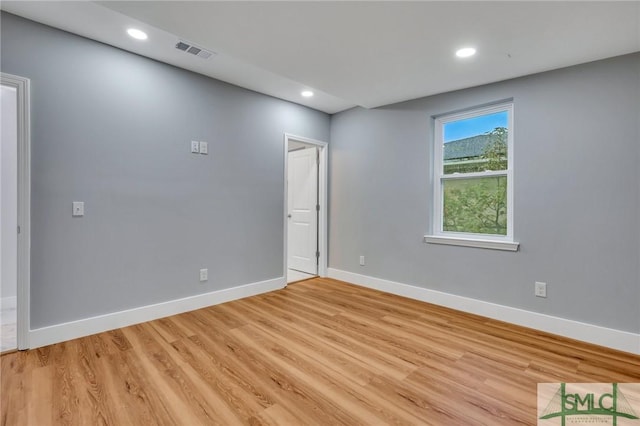 spare room featuring light hardwood / wood-style floors