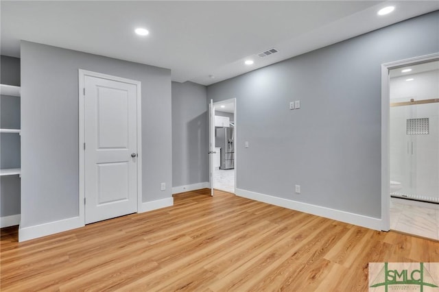 spare room featuring light wood-type flooring