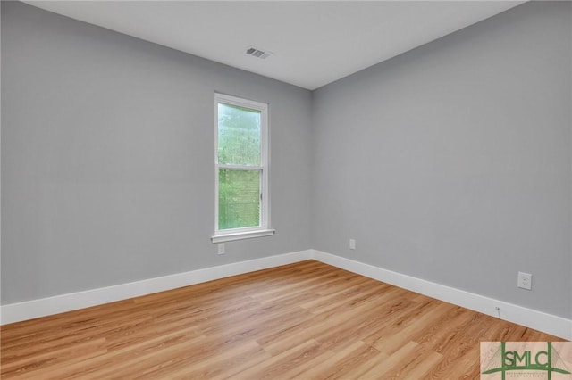 empty room featuring light wood-type flooring and a wealth of natural light