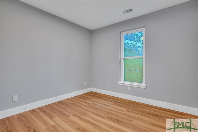 unfurnished room with light wood-type flooring