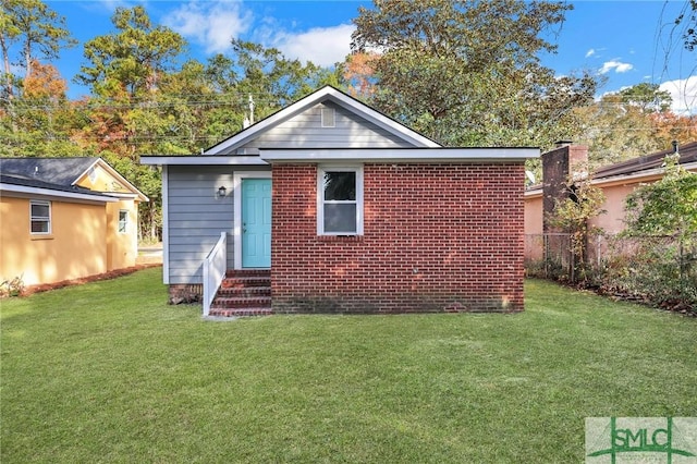 back of house with a lawn