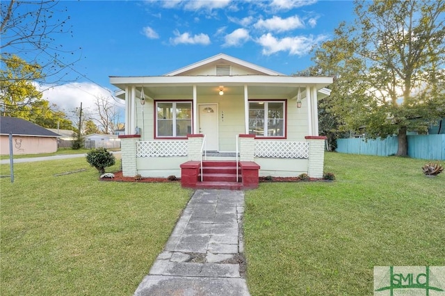 bungalow-style house featuring a porch and a front lawn