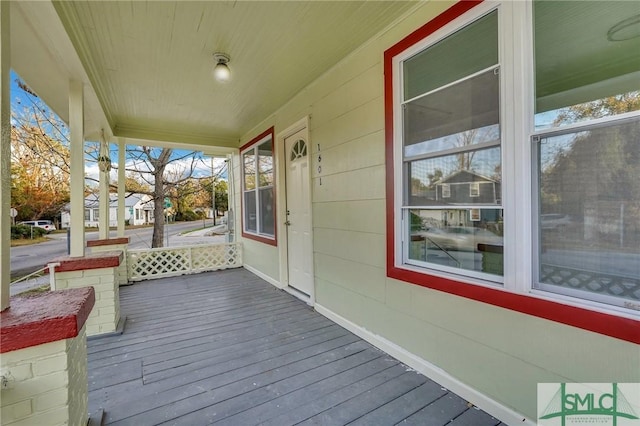 wooden terrace with a porch