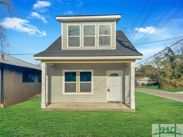 rear view of house with a yard