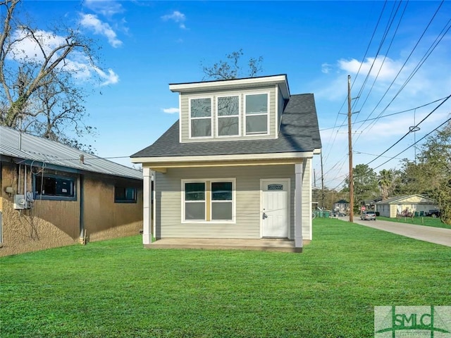 rear view of property featuring a lawn