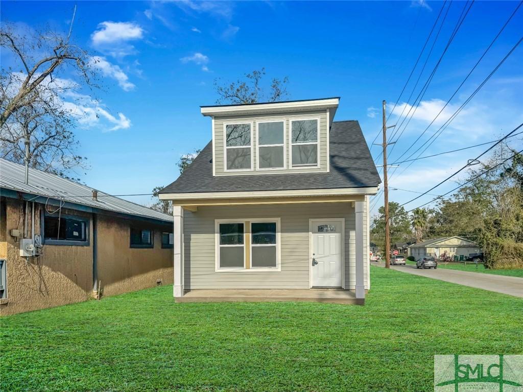 rear view of house with a lawn