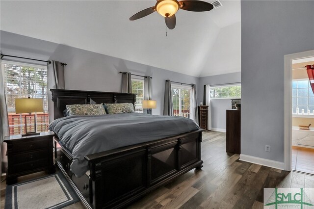 bedroom with ceiling fan, ensuite bath, dark wood-type flooring, and multiple windows