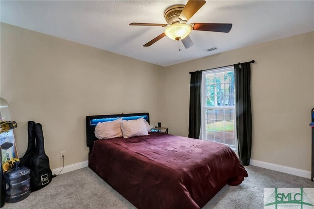 carpeted bedroom with ceiling fan