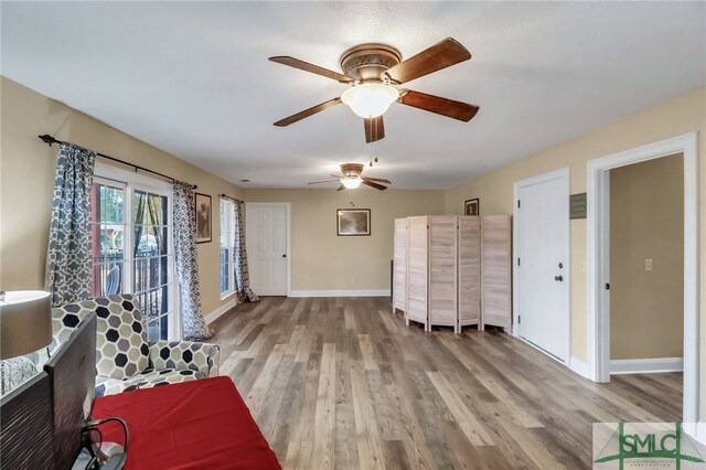 interior space featuring hardwood / wood-style floors and ceiling fan