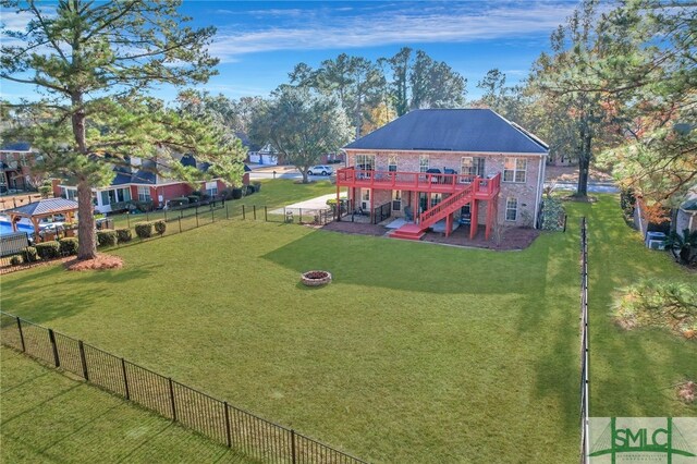 view of yard with a patio, a deck, and an outdoor fire pit