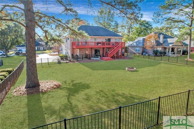 view of yard featuring an outdoor fire pit and a wooden deck