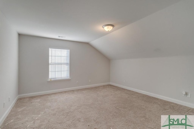 bonus room with light carpet and lofted ceiling