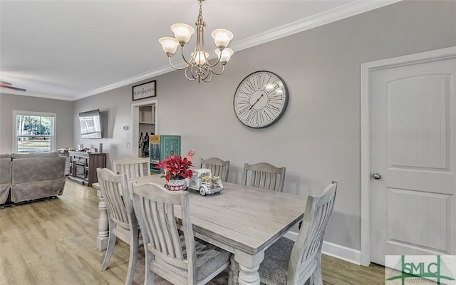 dining area featuring crown molding, wood-type flooring, and an inviting chandelier