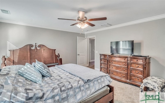 carpeted bedroom with ceiling fan and crown molding