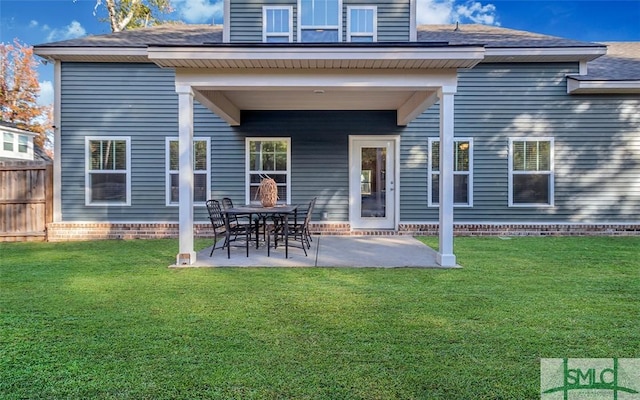 rear view of property with a patio area and a lawn