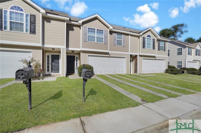 townhome / multi-family property with a front yard and a garage