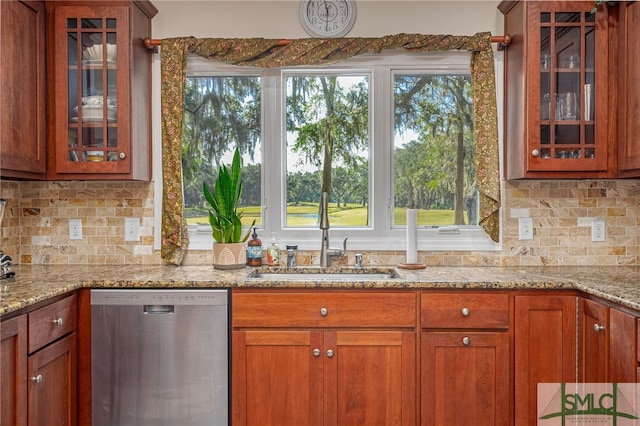 kitchen featuring dishwasher, light stone counters, and a wealth of natural light