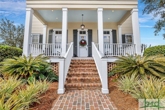 view of exterior entry with a porch