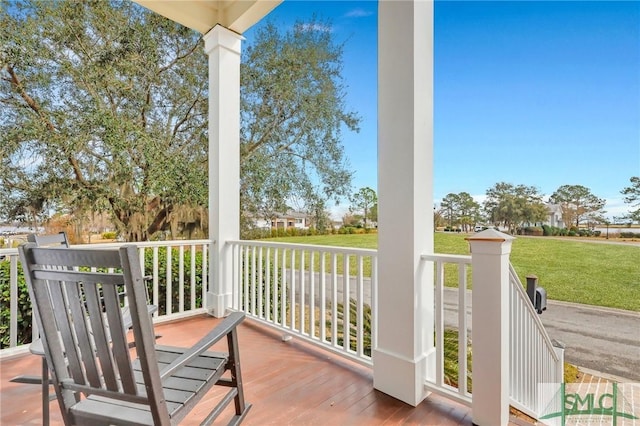 deck with a porch and a lawn