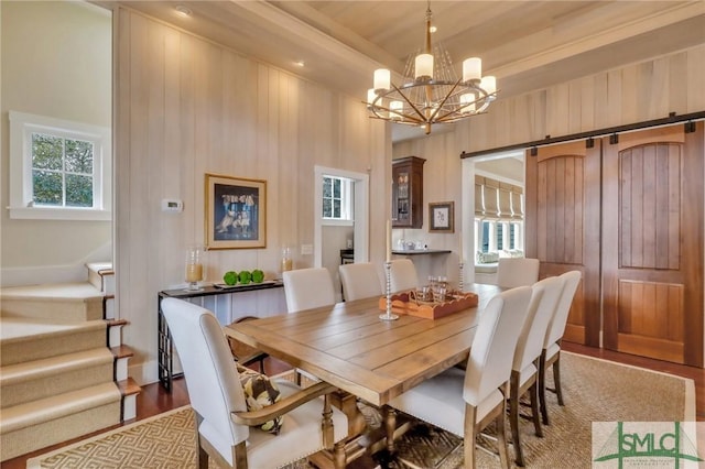 dining room with dark hardwood / wood-style flooring, a towering ceiling, and a chandelier