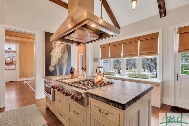 kitchen featuring hardwood / wood-style floors, lofted ceiling with beams, a kitchen island, island range hood, and stainless steel gas cooktop