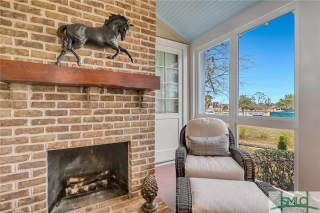 sunroom / solarium featuring a fireplace and vaulted ceiling