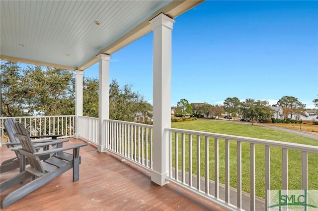 deck featuring a lawn and covered porch