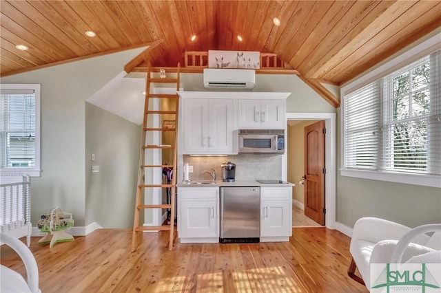 kitchen with white cabinets, appliances with stainless steel finishes, vaulted ceiling, and wood ceiling