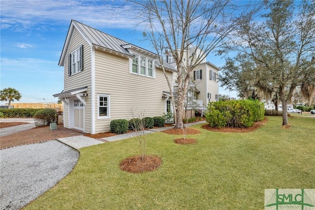 view of side of property featuring a garage and a lawn