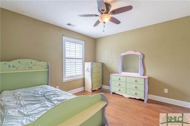 bedroom featuring ceiling fan, a textured ceiling, and hardwood / wood-style flooring