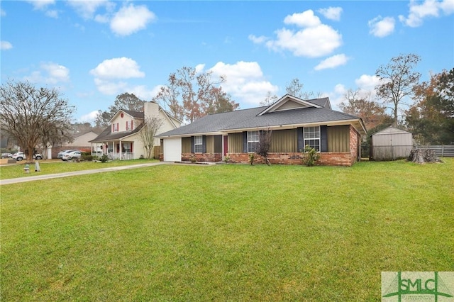 view of front of house featuring a garage, a front yard, and a storage shed